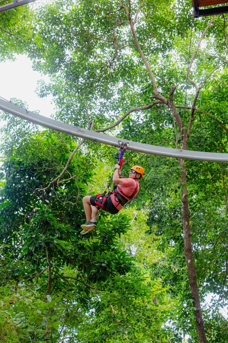 Helmeted rider suspended below the curved Roller Rock track