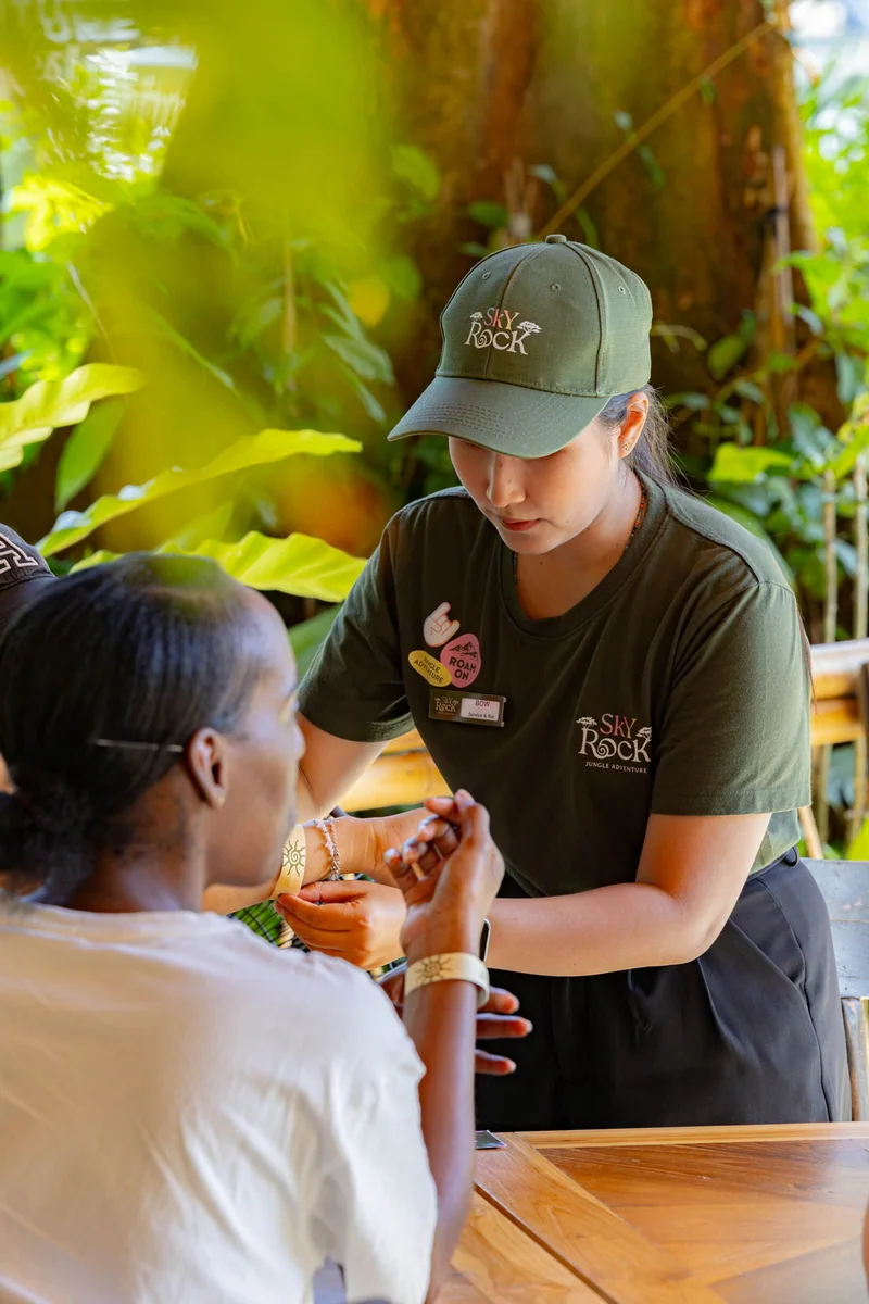 Sky Rock staff member assisting a participant in the preparation area
