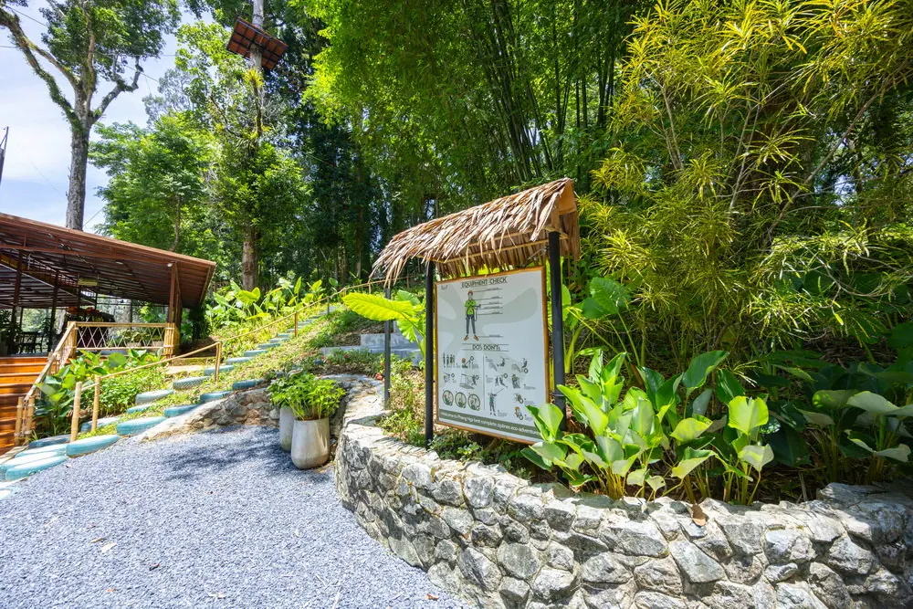 Sky Rock entrance sign beside landscaped greenery and the arrival building